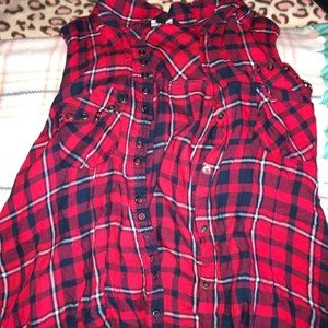 Button up sleeveless plaid shirt.